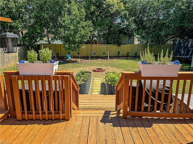 deck featuring a fire pit and a lawn