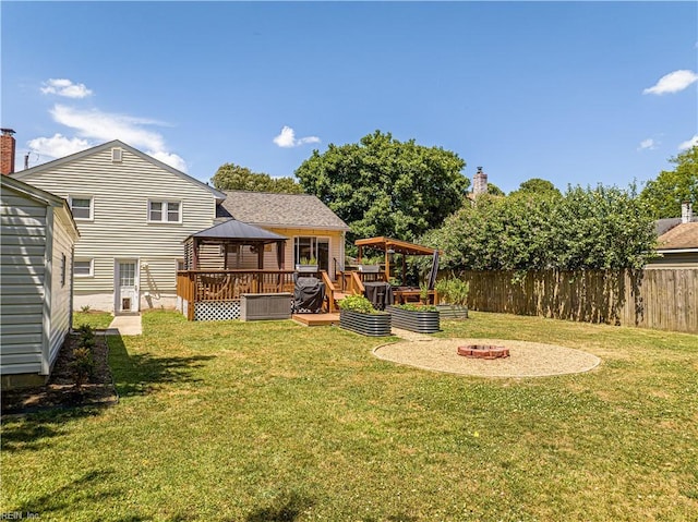 view of yard with a fire pit, a wooden deck, and a gazebo