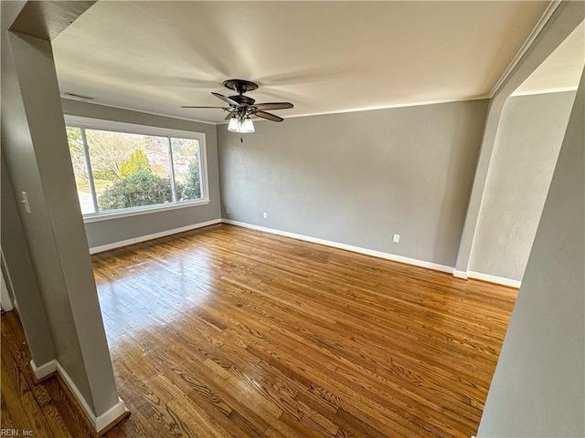 spare room featuring hardwood / wood-style floors and ceiling fan