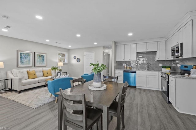 dining space featuring sink and light hardwood / wood-style flooring