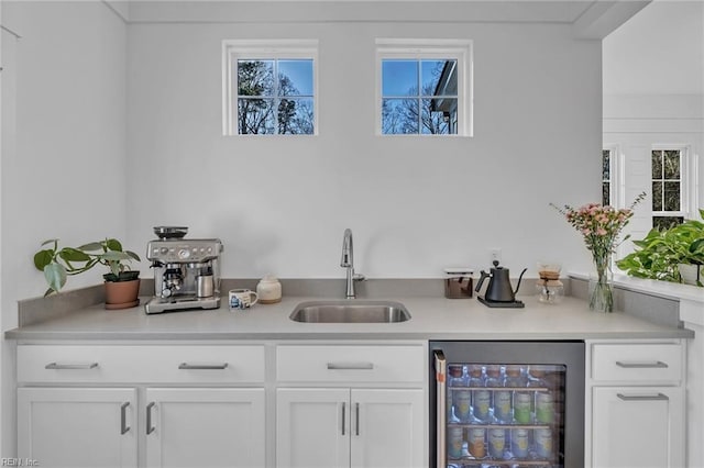 bar featuring white cabinetry, sink, a wealth of natural light, and wine cooler