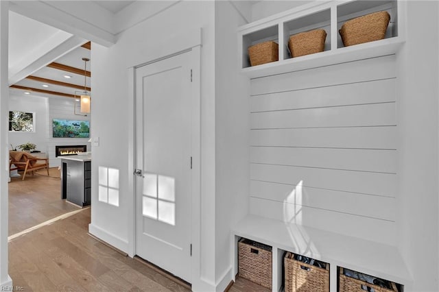 mudroom featuring hardwood / wood-style floors and beam ceiling