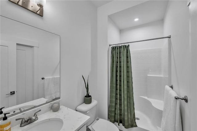 bathroom with toilet, vanity, and a shower with shower curtain