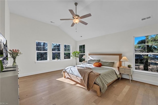 bedroom with light hardwood / wood-style flooring, ceiling fan, and vaulted ceiling