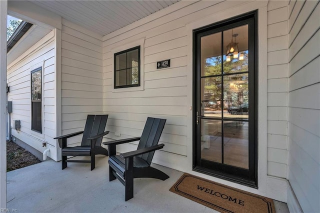 view of exterior entry featuring covered porch