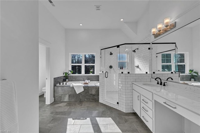 full bathroom featuring shower with separate bathtub, vanity, and toilet