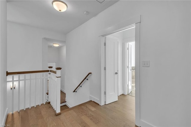 corridor with light hardwood / wood-style floors