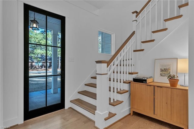 staircase featuring hardwood / wood-style flooring and a wealth of natural light