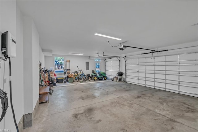 garage featuring a garage door opener and electric panel