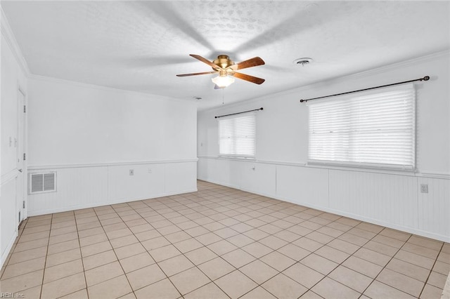 spare room featuring crown molding, a textured ceiling, and ceiling fan