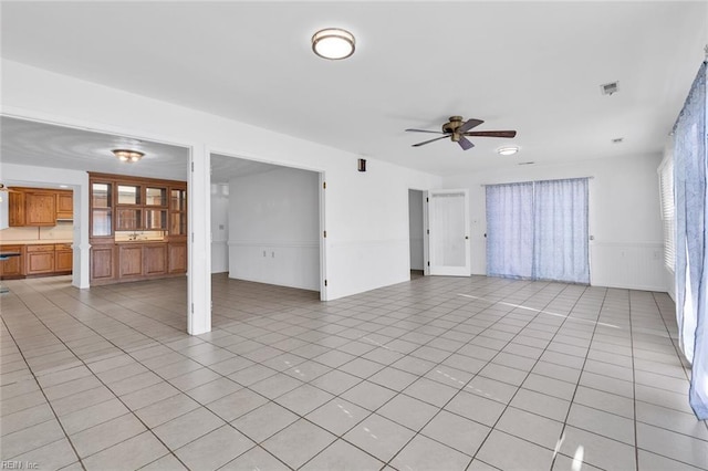 unfurnished living room with light tile patterned flooring and ceiling fan