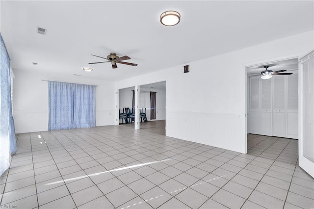 empty room featuring ceiling fan and light tile patterned floors