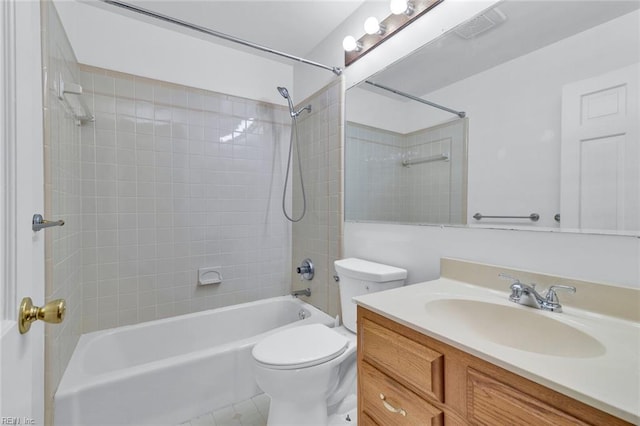 full bathroom with tiled shower / bath, vanity, and toilet