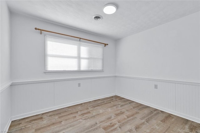 spare room featuring light wood-type flooring