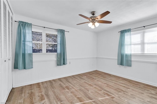 empty room featuring light hardwood / wood-style flooring and ceiling fan