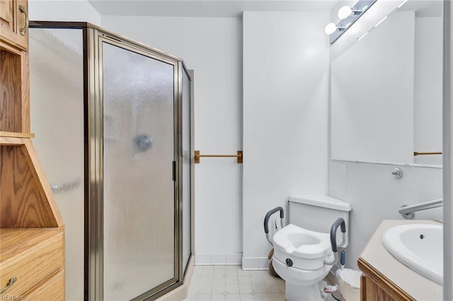 bathroom featuring vanity, a shower with shower door, and toilet