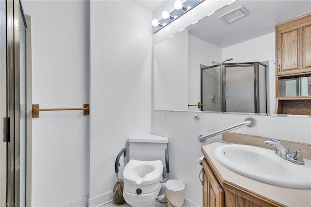 bathroom featuring vanity, a shower with door, and toilet