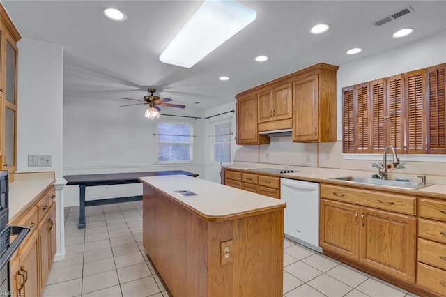 kitchen featuring sink, ceiling fan, dishwasher, black electric stovetop, and a kitchen island