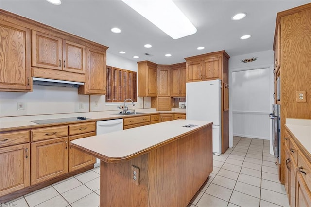 kitchen with white appliances, sink, a kitchen island, and light tile patterned floors