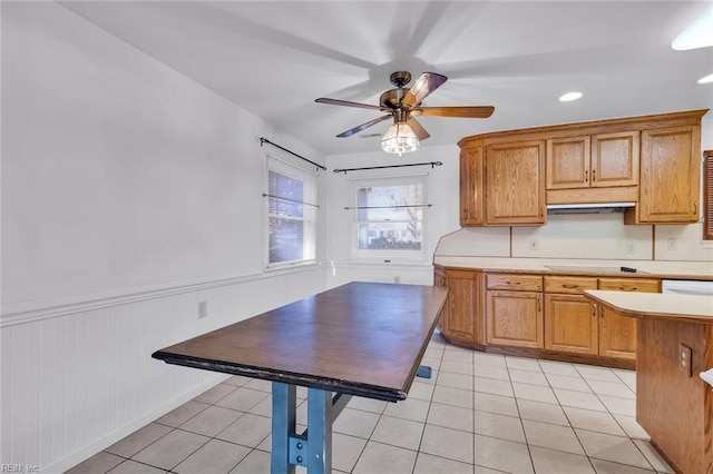 kitchen with ceiling fan, stovetop, and light tile patterned floors