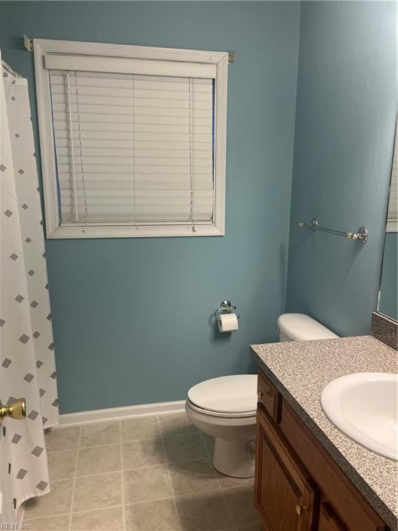 bathroom with vanity, toilet, and tile patterned flooring