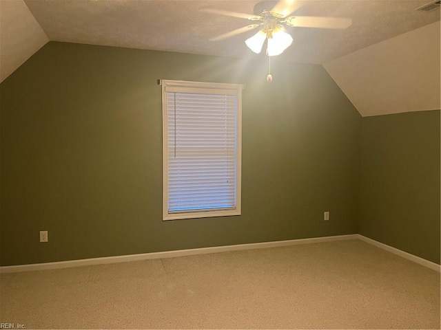 bonus room with lofted ceiling, carpet flooring, a textured ceiling, and ceiling fan