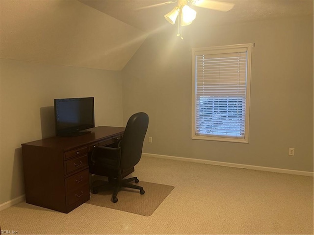 carpeted office space featuring vaulted ceiling and ceiling fan