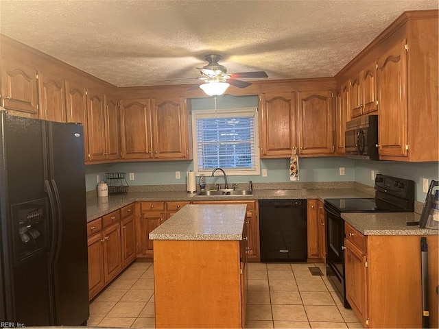 kitchen with sink, light tile patterned floors, a kitchen island, ceiling fan, and black appliances