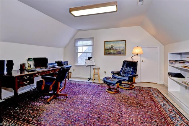 home office with light carpet and vaulted ceiling