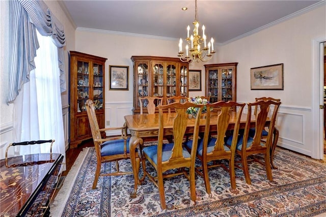 dining area with an inviting chandelier, hardwood / wood-style floors, and crown molding