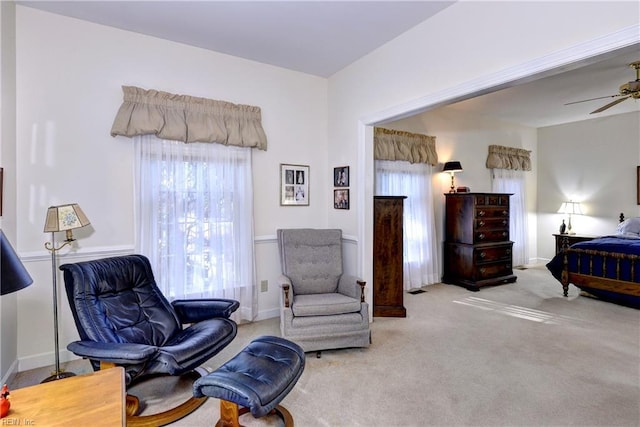 sitting room featuring light colored carpet and ceiling fan