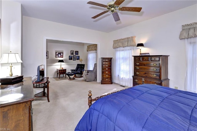 bedroom with light carpet and ceiling fan