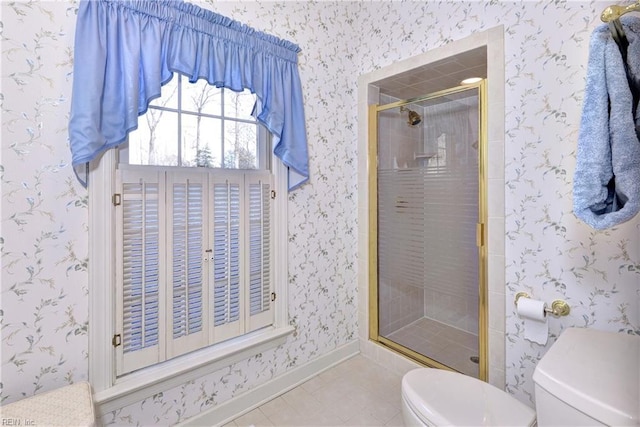 bathroom featuring tile patterned flooring, a shower with shower door, and toilet