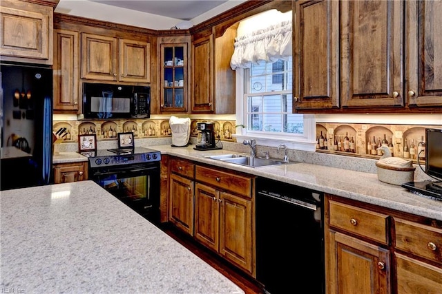 kitchen with tasteful backsplash, sink, light stone counters, and black appliances