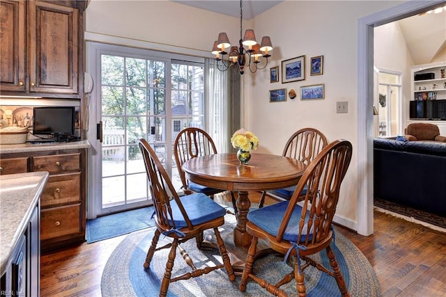 dining area featuring vaulted ceiling, dark hardwood / wood-style floors, and a chandelier