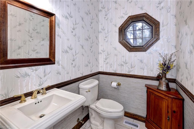 bathroom with tile patterned flooring, sink, and toilet