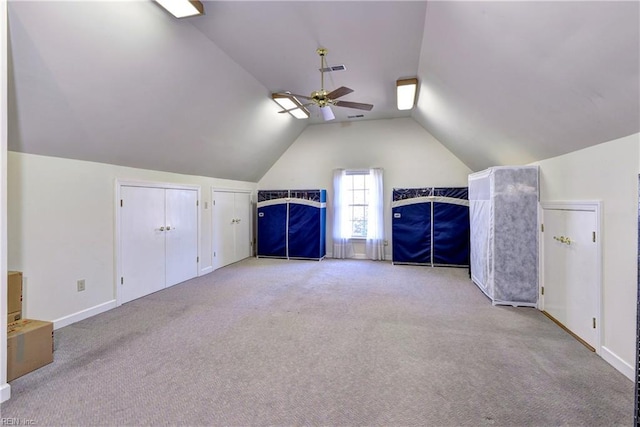 additional living space with ceiling fan, lofted ceiling, and light colored carpet