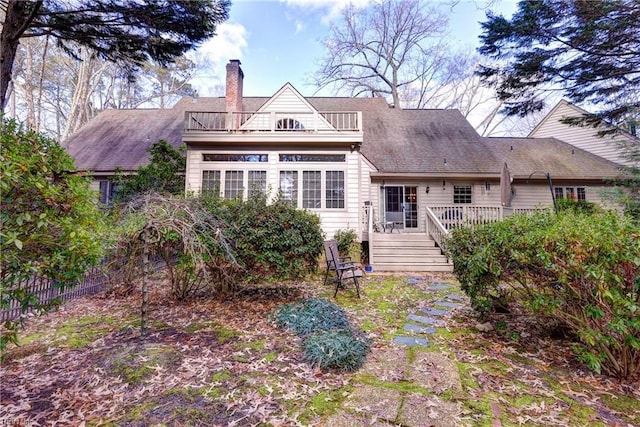 back of property with a balcony