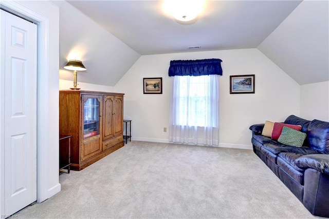 carpeted living room featuring lofted ceiling