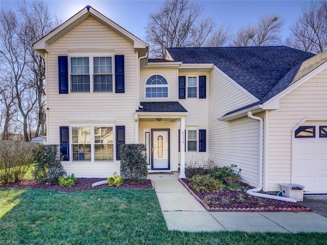 view of front of house featuring a garage and a front yard