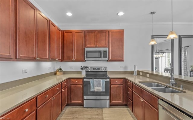 kitchen featuring sink, crown molding, hanging light fixtures, and appliances with stainless steel finishes