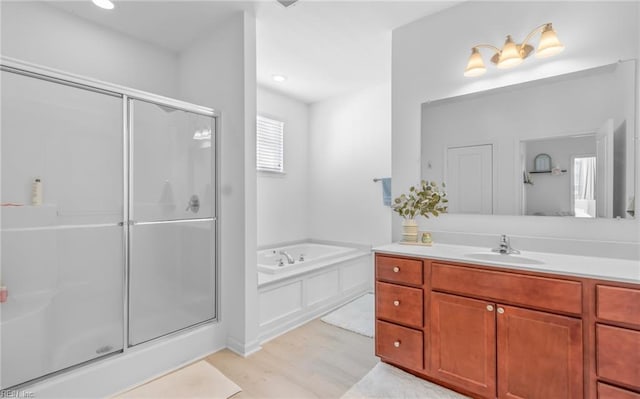 bathroom with vanity, plus walk in shower, and hardwood / wood-style floors