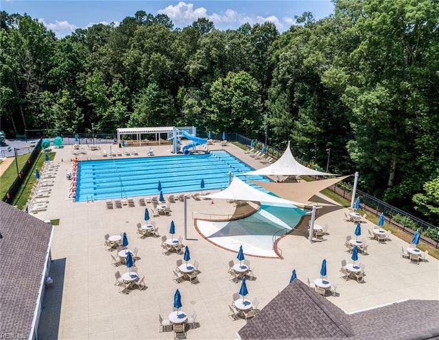 view of pool featuring a patio and a water slide