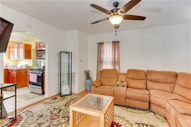 tiled living room with ceiling fan