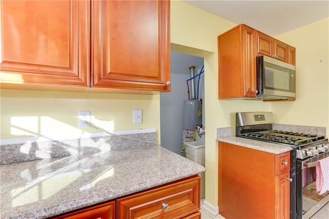 kitchen with gas water heater and appliances with stainless steel finishes