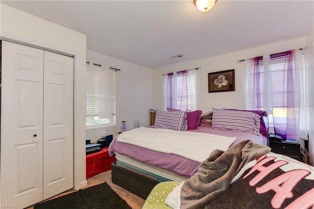 carpeted bedroom featuring a closet