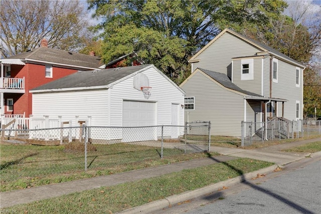 view of home's exterior featuring a garage, an outdoor structure, and a yard