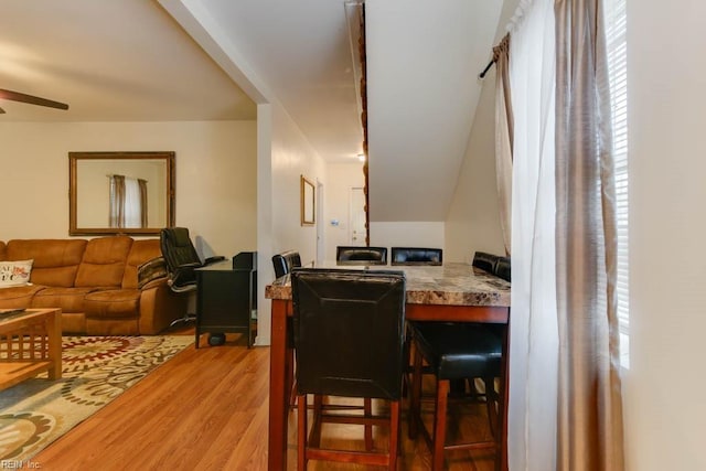 dining space with ceiling fan and light hardwood / wood-style floors