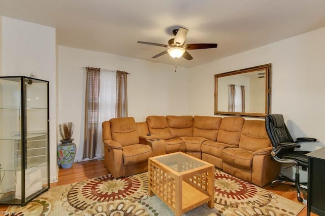 living room with ceiling fan and light hardwood / wood-style floors