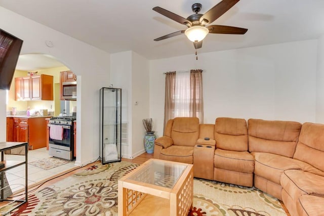 tiled living room featuring ceiling fan